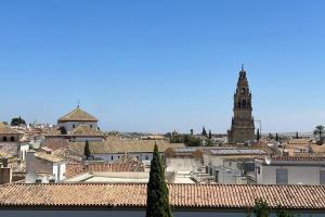 a view of a city with a clock tower at El Sabil de la Mezquita in Córdoba