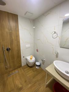 a bathroom with a toilet and a sink at Villa Juli Ksamil in Ksamil