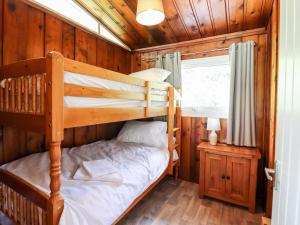 a bedroom with a bunk bed in a cabin at Chalet 2 in Machynlleth