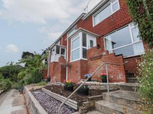 a brick house with a garden in front of it at Terrace Views in Torquay
