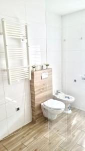 a white bathroom with a toilet and a sink at Dom nad Jeziorami in Łubowo +54 photos