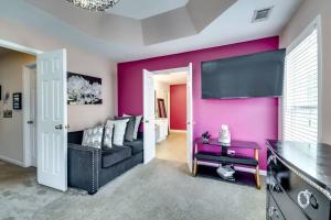 een woonkamer met een bank en een roze muur bij Seize the Moment and Enjoy Life! in Hiram