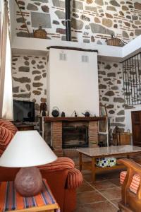 a living room with a couch and a fireplace at Piedras Vivas in Anora