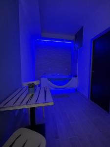a blue room with a table and a bath tub at Blue Suite in Mola di Bari