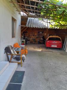 a garage with a red car parked in it at Casa Olga Deva in Deva