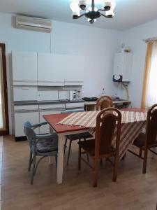 uma cozinha com mesa e cadeiras num quarto em Casa Olga Deva em Deva