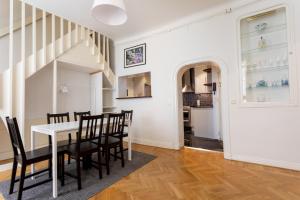 a kitchen and dining room with a table and chairs at ApartDirect Gamla Stan III in Stockholm