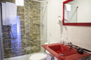 a bathroom with a red sink and a shower at La Casa de los Faroles in Córdoba +39 photos