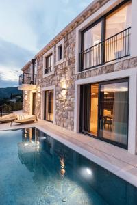 a house with a swimming pool in front of it at Villa Val & Sol in Dubrovnik