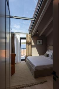 a bedroom with a bed and a view of the ocean at Villa Val & Sol in Dubrovnik +27 photos