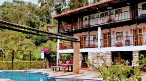 a resort with a swimming pool and a building at 5ta SARoCO Hacienda Biocultural y Agroecoturistica in Silvania