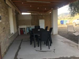 a black table and chairs on a patio at green holiday in Castiglione della Pescaia