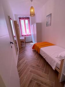 Ένα ή περισσότερα κρεβάτια σε δωμάτιο στο Casa Vacanze Nuanua