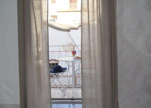ventana con vistas a un balcón con mesa en Meridiana case al mare centro, en Mattinata