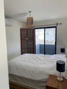 a bedroom with a white bed and a window at Chakana Lofts in El Pescadero