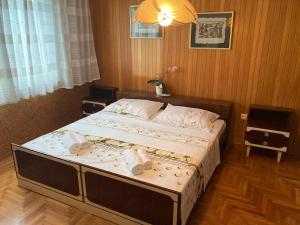 a bedroom with a large bed with towels on it at 7 Flower Street Apartment in Šempeter pri Gorici