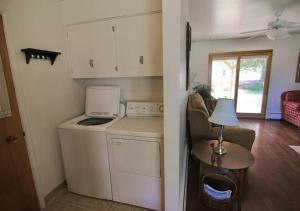 a kitchen with a washer and a table with a lamp at Horsehead Haven in Monticello in Monticello +39 photos