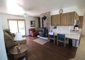 a kitchen and living room with a table and a fireplace at Horsehead Haven in Monticello in Monticello