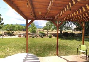 a wooden pergola with a table and a chair at Horsehead Haven in Monticello in Monticello