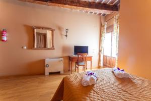 Postel nebo postele na pokoji v ubytování Hotel Rincón Castellano