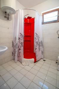 a bathroom with a red cabinet in the shower at Crystal in Ohrid