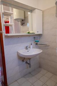 a bathroom with a white sink and a mirror at Crystal in Ohrid