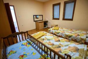 a bedroom with two beds and a desk with a mirror at Crystal in Ohrid