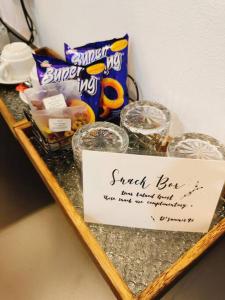 a shelf with snacks and a sign on it at Pavilion Bukit Jalil Revo@Aurora By D'Summer91 in Kuala Lumpur