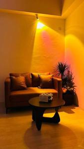 a living room with a couch and a table at Pavilion Bukit Jalil Revo@Aurora By D'Summer91 in Kuala Lumpur