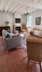 a living room with a couch and chairs at Gîte-Région centre-Sologne 41 proche Lamotte Beuvron in Nouan-le-Fuzelier