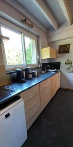 a kitchen with a blue counter top and a window at Gîte-Région centre-Sologne 41 proche Lamotte Beuvron in Nouan-le-Fuzelier