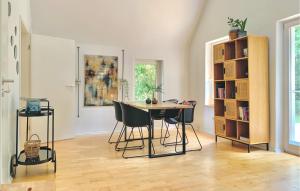 a room with a table and chairs and a book shelf at Stunning Home In Morschen With Kitchen in Morschen