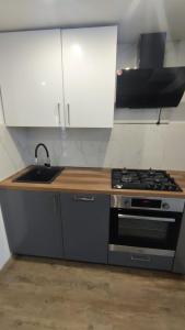 a kitchen with a sink and a stove at Stare Miasto in Kłodzko