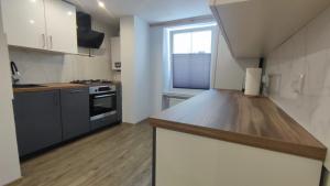a kitchen with a wooden counter top in a room at Stare Miasto in Kłodzko
