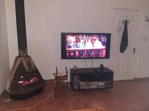 a living room with a fireplace and a television at Pearly Beach Fish Relax in Pearly Beach