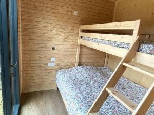 a small bedroom with two bunk beds in it at La Cabane du Petit Moulin in Bressuire