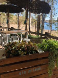 una valla de madera con mesa, sillas y plantas en Casa Rural Apartamento "Isla del Zújar", en Castuera