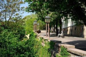 a person sitting on a bench next to a street light at Small Peace Oasis in Zagreb