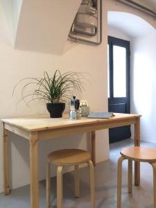 a wooden table with two chairs and a plant on it at Small Peace Oasis in Zagreb