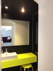 a bathroom with a sink and a mirror and a stool at Small Peace Oasis in Zagreb