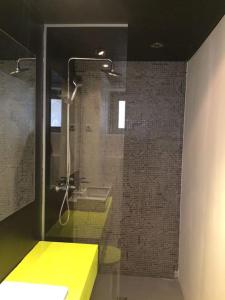 a bathroom with a shower with a yellow counter at Small Peace Oasis in Zagreb