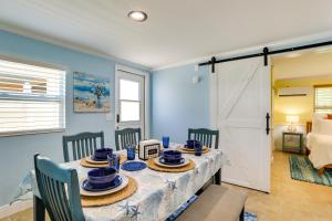 a dining room with a table and chairs and a door at Bradenton Vacation Rental Gas Grill and Water Views in Bradenton
