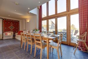 a dining room with a wooden table and chairs at Work Shop, Rookery Farm in West Beckham