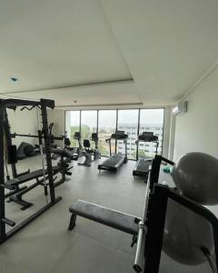 a gym with several treadmills and machines in a room at Luxury Cantonments Suite in Accra