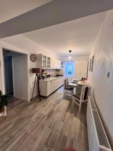 a kitchen and dining room with a table and chairs at Sweet Home Apartament in Predeal