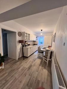 a kitchen and dining room with a table and chairs at Sweet Home Apartament in Predeal