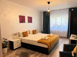 a bedroom with a large bed with towels on it at Sweet Home Apartament in Predeal