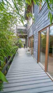 a wooden walkway leading up to a building at Beautiful garden apartment with private patio and garden view in Dublin