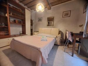 a bedroom with a bed and a desk in it at La Bomboniera di Siena in Siena