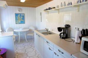 a small kitchen with a sink and a table at Ruegen_Fewo 67_1 in Thesenvitz